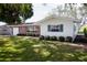 Charming single-story home with a brick facade, manicured lawn, and an attached one-car garage at 2010 6Th Sw Ave, Largo, FL 33770
