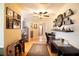Inviting hallway featuring hardwood floors, decorative shelving, and a view into the living area at 2010 6Th Sw Ave, Largo, FL 33770