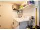 Functional laundry room with a washing machine and storage shelving at 2010 6Th Sw Ave, Largo, FL 33770