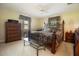 Cozy main bedroom featuring a wrought iron bed frame, two windows, and soft carpet at 2010 6Th Sw Ave, Largo, FL 33770