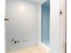 Utility room with blue walls and concrete floors, featuring exposed pipes at 2010 6Th Sw Ave, Largo, FL 33770