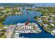 Waterfront homes featuring canal access and a shared pool, surrounded by a serene aquatic landscape at 2011 Ketch Cir, Palm Harbor, FL 34683