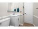 Bathroom with a toilet and vanity with a white cabinet at 2011 Ketch Cir, Palm Harbor, FL 34683