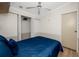 Bedroom features a blue bedspread, ceiling fan and closet at 2011 Ketch Cir, Palm Harbor, FL 34683