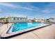 Community pool with view of homes, partially cloudy sky at 2011 Ketch Cir, Palm Harbor, FL 34683