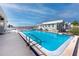 Community pool with views of the water and blue skies at 2011 Ketch Cir, Palm Harbor, FL 34683