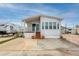 Inviting home with covered front porch and well maintained landscaping and a long driveway at 2011 Ketch Cir, Palm Harbor, FL 34683