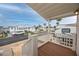 Inviting outdoor porch with white railings and wood flooring with community view at 2011 Ketch Cir, Palm Harbor, FL 34683