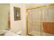 Bright bathroom featuring a glass enclosed shower and decorative wall art at 2038 Oswego Dr, Holiday, FL 34691