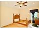 This cozy bedroom offers a comfortable space with a ceiling fan and bright window at 2038 Oswego Dr, Holiday, FL 34691