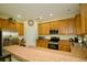Kitchen featuring stainless steel appliances, ample cabinet space, and breakfast bar at 2038 Oswego Dr, Holiday, FL 34691