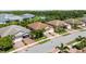 Aerial view of residential neighborhood featuring manicured lawns, brick driveways, and lush landscaping at 21008 Fetterbush Pl, Venice, FL 34293