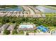 Aerial view of community featuring homes surrounding lakes, community pool, bocce ball and tennis courts at 21008 Fetterbush Pl, Venice, FL 34293