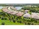 A picturesque aerial view of a residential community with lush landscaping surrounding the lake at 21008 Fetterbush Pl, Venice, FL 34293
