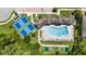 Overhead shot of the community pool, tennis courts, bocce ball court, and lush landscaping at 21008 Fetterbush Pl, Venice, FL 34293
