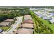 Aerial view showcases a community with mature trees, water features, and well-maintained properties at 21008 Fetterbush Pl, Venice, FL 34293