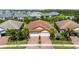Aerial shot of property showcasing manicured landscaping, brick driveway, and tile roof at 21008 Fetterbush Pl, Venice, FL 34293