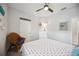 Comfortable bedroom with wicker chair and light colored walls at 21008 Fetterbush Pl, Venice, FL 34293