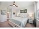 Bright bedroom featuring a comfortable bed, and tropical themed decor at 21008 Fetterbush Pl, Venice, FL 34293