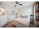 Bedroom with a ceiling fan, white dresser, and decorative accents at 21008 Fetterbush Pl, Venice, FL 34293