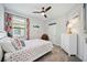 Cozy bedroom with a vibrant decor, carpet, and ceiling fan at 21008 Fetterbush Pl, Venice, FL 34293