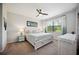 Bedroom with a ceiling fan, bedside tables and tropical themed decor at 21008 Fetterbush Pl, Venice, FL 34293