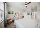 Bright bedroom with a ceiling fan, chair, and ample closet space at 21008 Fetterbush Pl, Venice, FL 34293