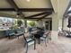 Community patio area with comfortable seating and ceiling fans for relaxing in the shade at 21008 Fetterbush Pl, Venice, FL 34293