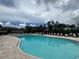 Inviting community pool with ample seating and a meticulously maintained surrounding area at 21008 Fetterbush Pl, Venice, FL 34293