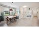 Light filled dining area with modern light fixture, seating for four, and neutral wall color at 21008 Fetterbush Pl, Venice, FL 34293