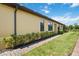 Well-maintained exterior with lush lawn, manicured shrubs, and a brick walkway at 21008 Fetterbush Pl, Venice, FL 34293