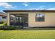 Exterior view featuring a screened-in lanai and well-kept landscaping around the home at 21008 Fetterbush Pl, Venice, FL 34293