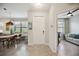 Inviting foyer featuring tile flooring, a decorative pelican painting, and views into the dining and living spaces at 21008 Fetterbush Pl, Venice, FL 34293