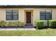 Charming front entrance with a brick pathway, tidy landscaping, and a welcoming dark-stained front door at 21008 Fetterbush Pl, Venice, FL 34293