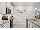 Well-equipped kitchen featuring granite countertops, stainless appliances, and white cabinetry at 21008 Fetterbush Pl, Venice, FL 34293