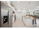 Modern kitchen featuring stainless steel appliances, granite countertops, and a large island at 21008 Fetterbush Pl, Venice, FL 34293