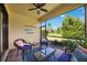 Screened lanai features stylish seating and a ceiling fan, perfect for enjoying outdoor views at 21008 Fetterbush Pl, Venice, FL 34293