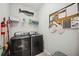 Well-organized laundry room equipped with a washer, dryer, and plenty of storage at 21008 Fetterbush Pl, Venice, FL 34293