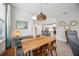 Open-concept living and dining area featuring tile flooring, stylish lighting, and a view into the kitchen at 21008 Fetterbush Pl, Venice, FL 34293