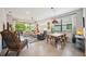 Open-concept living area with tile floors, comfortable seating, and a view of the screened patio at 21008 Fetterbush Pl, Venice, FL 34293