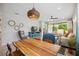 Bright living area with unique decor, tile flooring, and a view of the outdoor screened patio at 21008 Fetterbush Pl, Venice, FL 34293