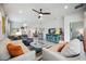 Bright open concept living area with neutral furniture, stylish decor, and modern lighting fixtures at 21008 Fetterbush Pl, Venice, FL 34293