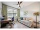 Comfortable office space with natural light, neutral tones, and a ceiling fan at 21008 Fetterbush Pl, Venice, FL 34293