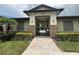 Community pool gate featuring stone accents and lush landscaping at 21008 Fetterbush Pl, Venice, FL 34293