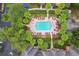 Aerial view of a resort-style pool, lush landscaping, and well-maintained community at 2171 Portofino Pl # 27-2725, Palm Harbor, FL 34683