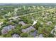 This aerial view highlights the property's location within a lush, tree-filled community near a golf course at 2171 Portofino Pl # 27-2725, Palm Harbor, FL 34683