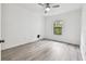Bedroom showcasing wood-look floors, a ceiling fan, and a window with natural light at 2171 Portofino Pl # 27-2725, Palm Harbor, FL 34683