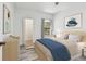 Bedroom showing a blue blanket on the bed and wood-look laminate flooring at 2171 Portofino Pl # 27-2725, Palm Harbor, FL 34683