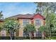 Charming exterior with colorful stucco, tile roof, and lush landscaping at 2171 Portofino Pl # 27-2725, Palm Harbor, FL 34683
