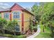 Attractive exterior with lush greenery and colorful stucco accents at 2171 Portofino Pl # 27-2725, Palm Harbor, FL 34683
